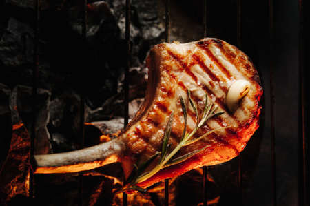 A top sirloin steak flame broiled on a barbecue, shallow depth of field.の写真素材