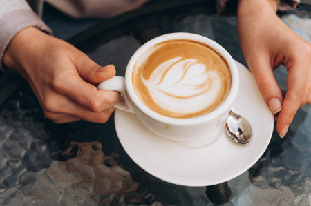 Young woman holding hot cup of coffee