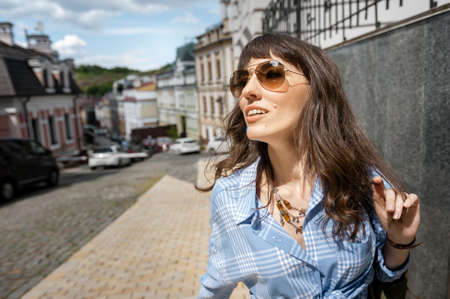 Girl tourist walks through the city and looks awayの写真素材