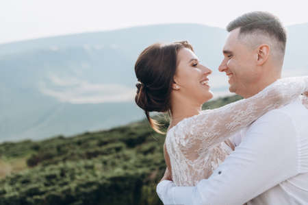 Newlyweds enjoy a wedding day in the mountainsの写真素材