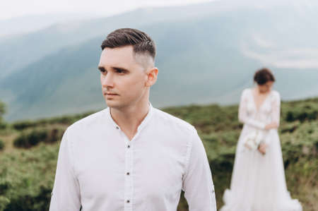 The first meeting of the newlyweds at sunset. Location in the mountainsの写真素材