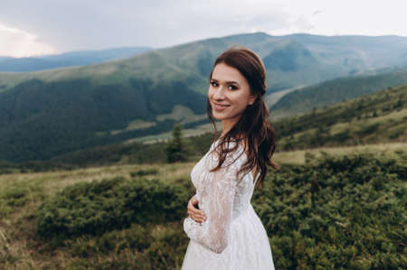 Portrait of a smiling bride against the backdrop of the mountainsの写真素材