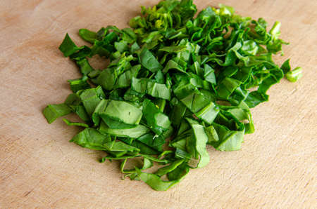 Spinach leaves chopped spinach on a wooden board. diet food.の写真素材