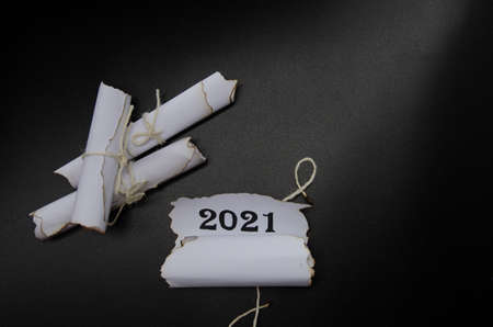 rolls of sheets of paper on a black background. Inscription 2021の写真素材