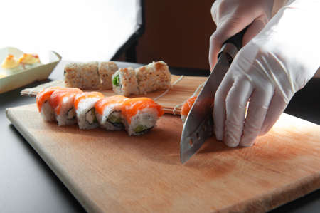 male cooks preparing sushi in the restaurant kitchenの写真素材