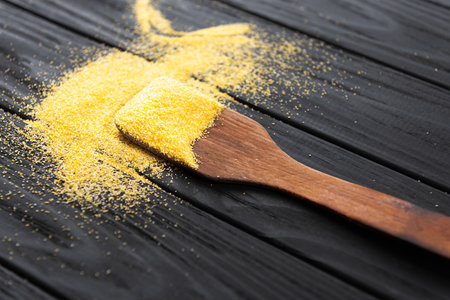 raw Italian corn porridge polenta on a dark stone backgroundの写真素材