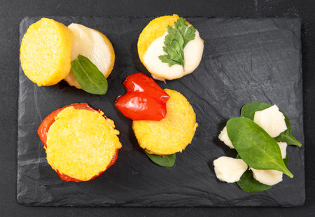 An alternative preparation of the Italian dish polenta. Fried corn porridge with different...