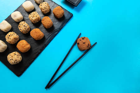 Mochi ice cream, blue background. four pieces of mochi with bitesの写真素材