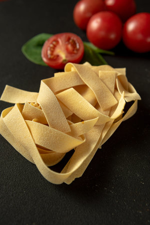 raw paste Pappardelle close-up vertical shot. Flat layの写真素材