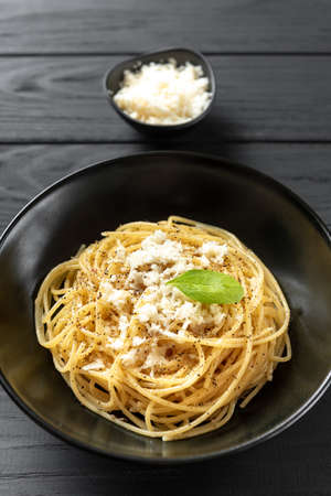 Italian pasta in a black plate. Cacio e Pepe - Italian Pastaの写真素材