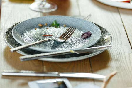 restaurant empty dirty plate. People ate food and left an empty plate in the restaurantの写真素材
