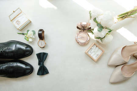 wedding accessories. Bride and grooms shoes, wedding ring watches, bridal bouquet. Top view.の写真素材