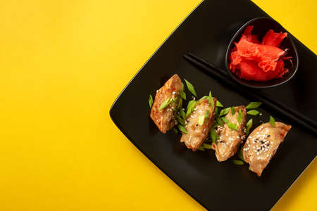 Original Japanese dumplings Gyoza with chicken and vegetables. Top view. Yellow background.の写真素材