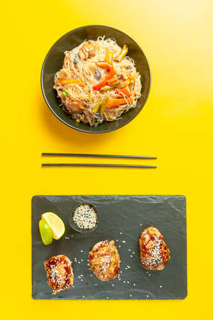food Asian cuisine. Asian or Szechuan noodles. Chinese wok noodles in a bowl with vegetables and teriyaki chickenの写真素材