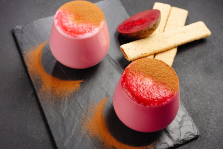 Two cups of beet latte on a dark background. Healthy eating alternative to caffeine