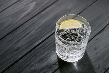 Hard seltzer with lime on a dark wooden backgroundの写真素材