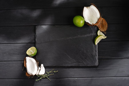 mock up slate with tropical fruits coconuts and limeの写真素材