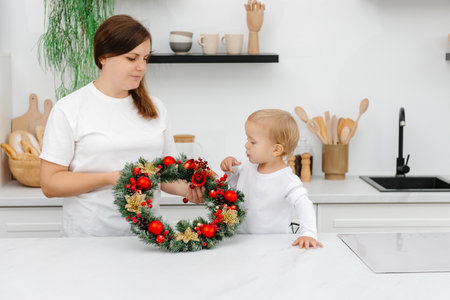 mother and son in the kitchen with Christmas decorations. New Years Eve preparationsの写真素材