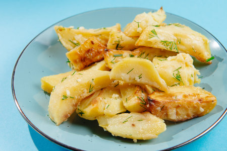 Healthy lifestyle, proper nutrition, ban on unhealthy foods.Fried potatoes in a plate on a blue...