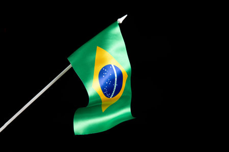 The Brazilian flag on a black background developing and fluttering in the wind