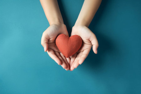 A person holding a heart in their handsの素材