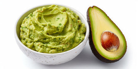 Avocado guacamole in bowl isolated on white background.の素材