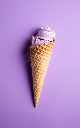 Vanilla ice cream in a waffle cone on a purple backgroundの素材