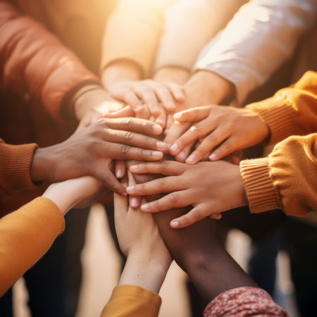 Group of multiethnic people holding hands on top of each otherの素材