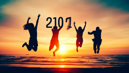 Silhouette of people jumping on the beach at sunset background. Concept of happy new year.の素材