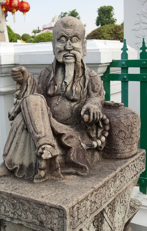 Chinese statue in the courtyard of the Buddhist temple of Wat Arun in Bangkok, Thailandの写真素材