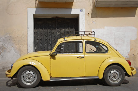 Yellow vintage VW Beetle on the street of Puebla, Mexicoのeditorial素材