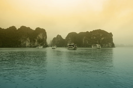 HALONG - FEBRUARY 28:Cruise boats in Halong Bay on February 28, 2013 HALONG, VIETNAM. Halong Bay is a UNESCO World Heritage Site and it is one of the prime travel destinations in Vietnamのeditorial素材