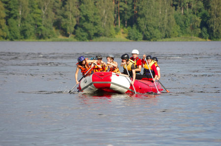 LOSEVO - AUGUST 18: Whitewater rafting on AUGUST 18, 2012 RUSSIA. Unidentified persons enjoy whitewater rafting on the Vuoksi river in Losevo, Leningrad region, Russiaのeditorial素材