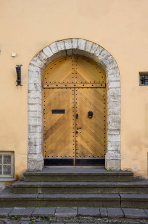 Wooden door of old stone house, Tallinn, Estoniaの写真素材