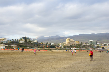 GRAN CANARIA, CANARY ISLANDS - JANUARY 01, 2014: Unidentified people walking from Playa del Ingles to Maspalomas along the coast of Atlantic ocean, Gran Canaria, Canary islands, Spainのeditorial素材