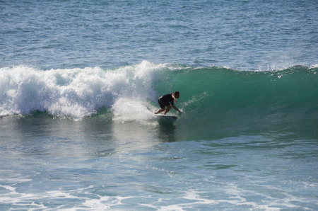 GRAN CANARIA, CANARY ISLANDS - JANUARY 05, 2014: Unidentified man surfing on a large wave on Playa del Ingles on the coast of Atlantic ocean, Gran Canaria, Canary islands, Spainのeditorial素材