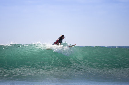 GRAN CANARIA, CANARY ISLANDS - JANUARY 05, 2014: Unidentified woman surfing on a large wave on Playa del Ingles on the coast of Atlantic ocean, Gran Canaria, Canary islands, Spainのeditorial素材