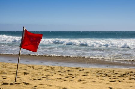 Red warning flag on the coast of Atlantic ocean, Gran Canaria, Canary islands, Spainの写真素材