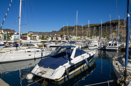 PUERTO DE MOGAN, GRAN CANARIA, CANARY ISLANDS - JANUARY 04, 2014: Yachts in harbor of Puerto de Mogan, a small fishing port and resort on Gran Canaria Island, Spainのeditorial素材
