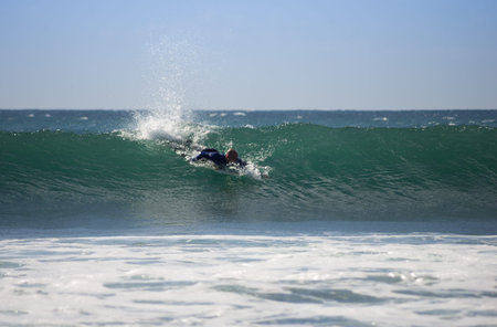 GRAN CANARIA, CANARY ISLANDS - JANUARY 05, 2014: Unidentified man surfing on a large wave on Playa...