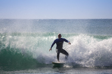 GRAN CANARIA, CANARY ISLANDS - JANUARY 05, 2014: Unidentified man surfing on a large wave on Playa...
