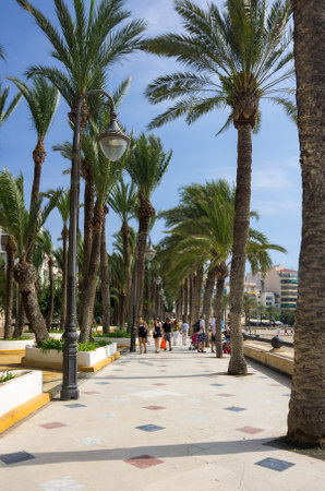 BENIDORM, SPAIN - OCTOBER 06, 2014: People walking on the embankment of Mediterranean resort Benidorm, province of Alicante, Spainのeditorial素材