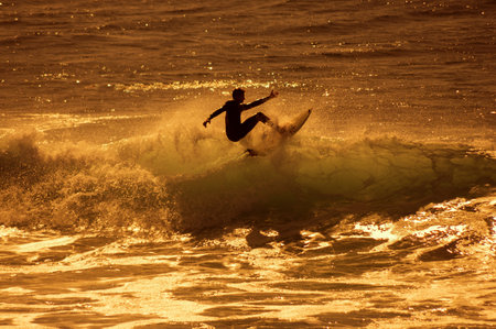 GRAN CANARIA, CANARY ISLANDS - JANUARY 05, 2014: Unidentified man surfing on a large wave on Playa del Ingles on the coast of Atlantic ocean, Gran Canaria, Canary islands, Spainのeditorial素材