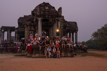 ANGKOR WAT, CAMBODIA - JANUARY 28, 2015: Tourists waiting for dawn at Angkor Wat temple in Cambodia. Angkor Wat is the largest Hindu temple complex and religious monument in the worldのeditorial素材