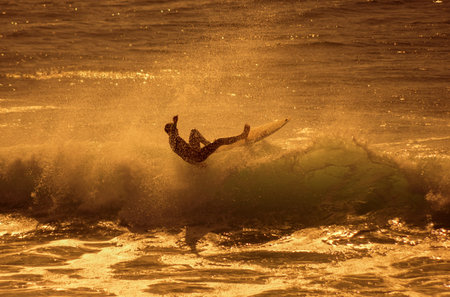Unidentified man surfing on a large wave on Playa del Ingles on the coast of Atlantic ocean, Gran...