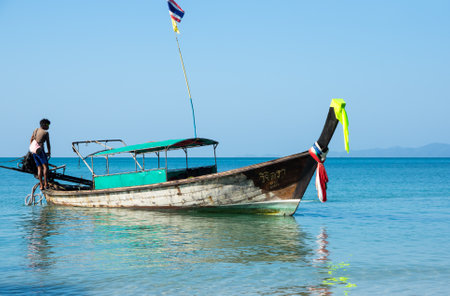 CRABI PROVINCE, THAILAND - FEBRUARY 04, 2015: Traditional thai long tail boat waiting for tourists to travel to beautiful islands in Thailandのeditorial素材