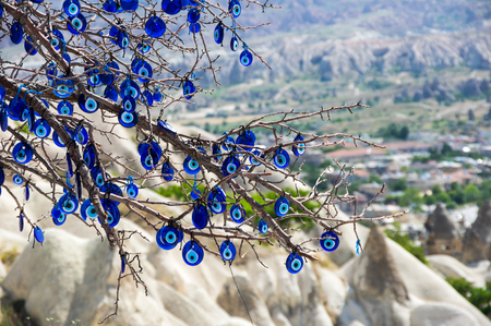 Evil eye hanging on the tree in Cappadocia valley, Turkeyの写真素材