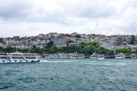 ISTANBUL, TURKEY - JUNE 25, 2015: Ferries are passing Bosphorus from Asia to Europe in Istanbul,...
