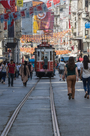 ISTANBUL, TURKEY - JUNE 26, 2015: A red classic tram in the crowded Istiklal street in the Beyoglu district of Istanbul, Turkey. It is the most famous street in Istanbulのeditorial素材