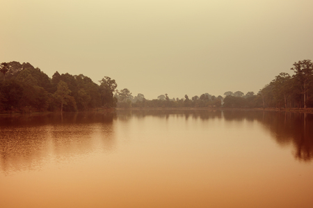Sunrise over lake at Angkor Thom in Siem Reap, Cambodia. Angkor Thom is a popular tourist attractionの写真素材